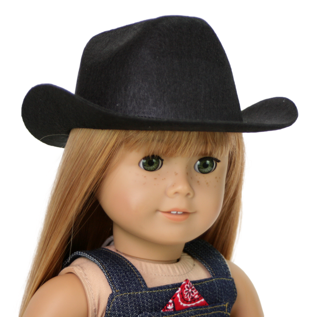 An 18" doll wearing a black cowboy hat and denim overalls with a red bandana on a white background