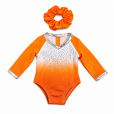 Orange ombre gymnastics leotard with sparkling rhinestones, silver trim, and matching orange scrunchie that fits an 18-inch doll