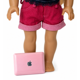 Pink toy laptop computer with reflective screen and realistic keyboard accessory for 18-inch dolls, displayed in front of an American Girl-sized doll on a white background.